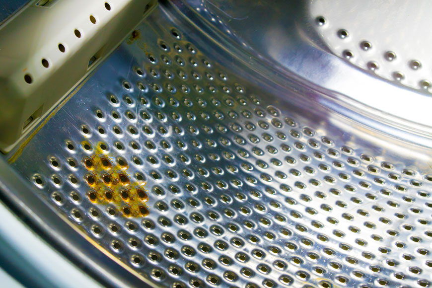 An ugly patch of rust is visible on a shiny new washing machine drum