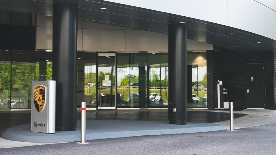 Reliance Foundry retractable bollards outside of a Porsche dealership.