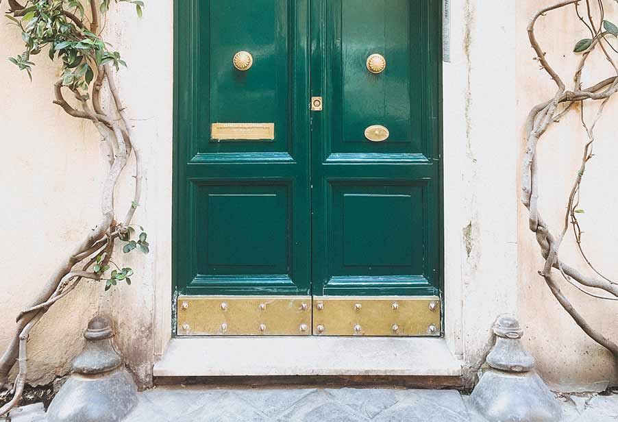 Brass kick plate on green door