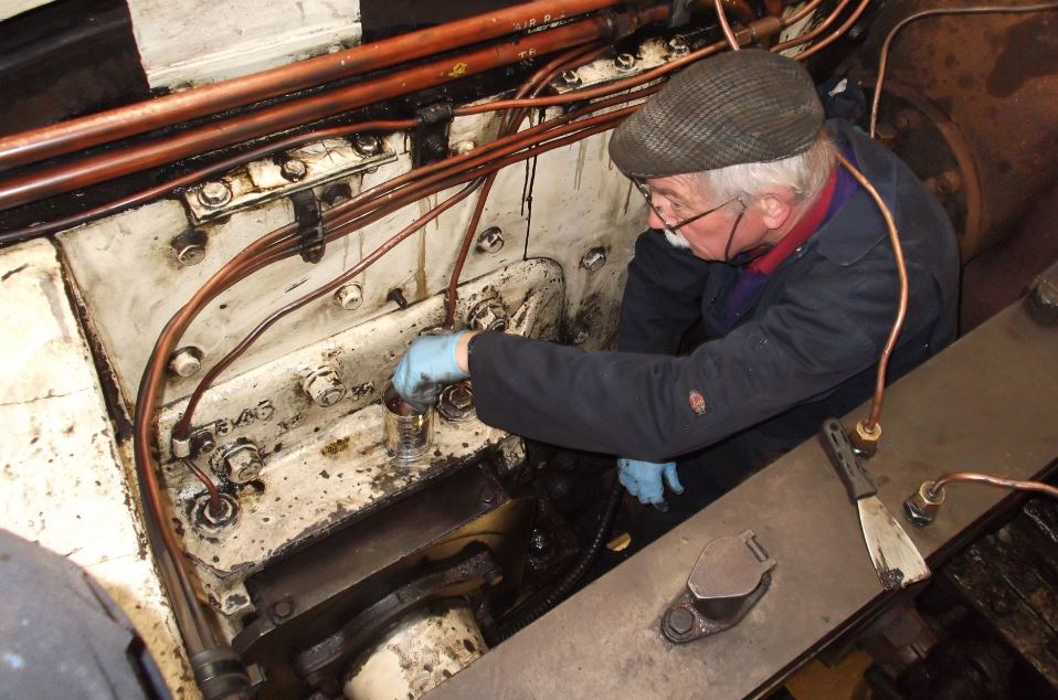 Bob Shearman cleaning between the frames. The white paint applied 10 years ago shows through. 