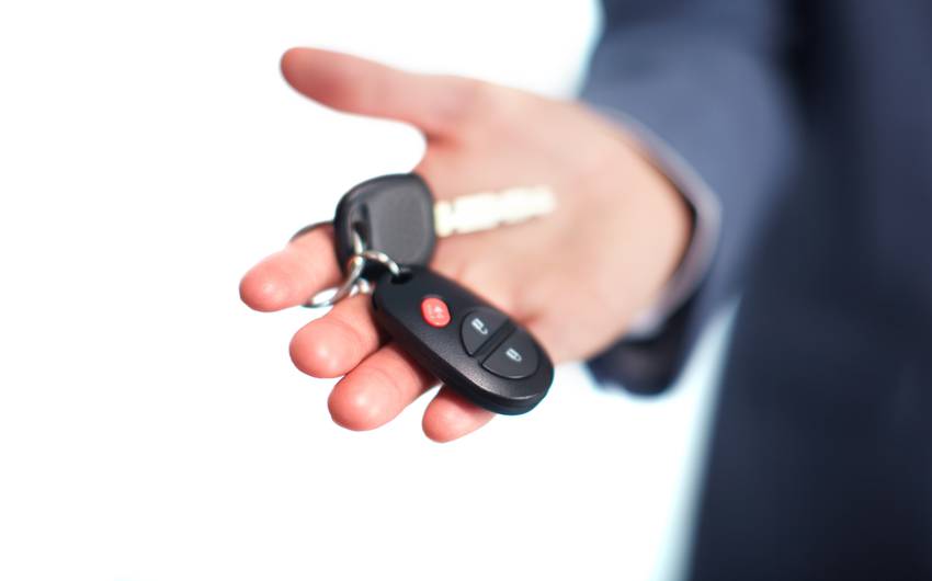 hand holding car key