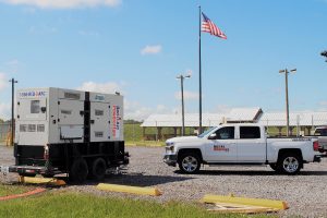 generator and truck in front of american flag